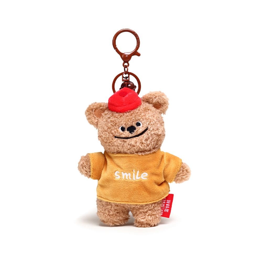 Chaveiro de pelúcia sorrindo com chapéu vermelho e capuz amarelo