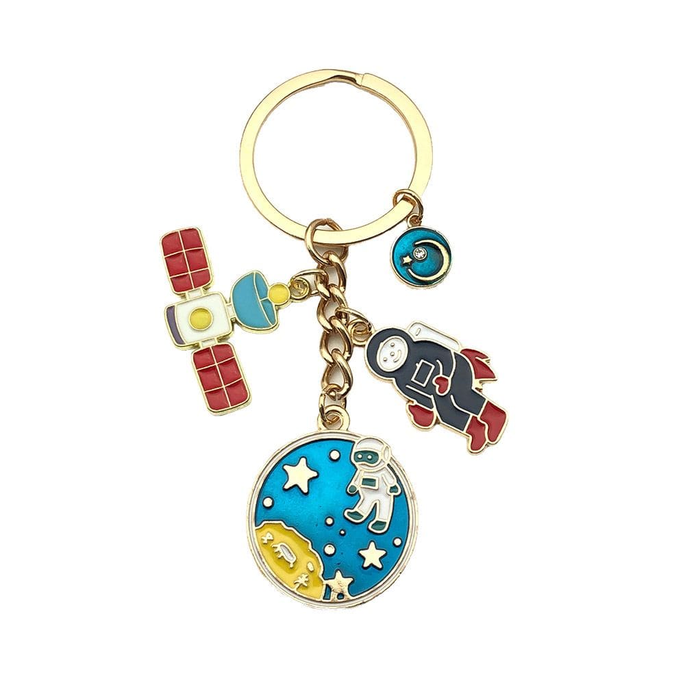 Chaveiro com tema espacial com astronauta, planeta e satélite